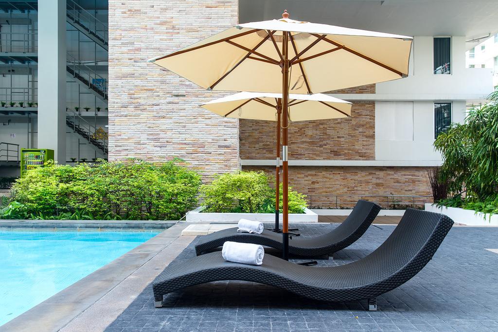 The Capital Resort @ Sukhumvit 50 Bangkok Exteriör bild Sunloungers by a pool